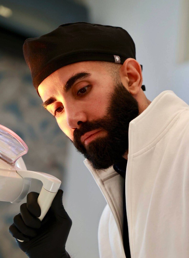 Dr. Nima Aziznia performing a dental treatment
